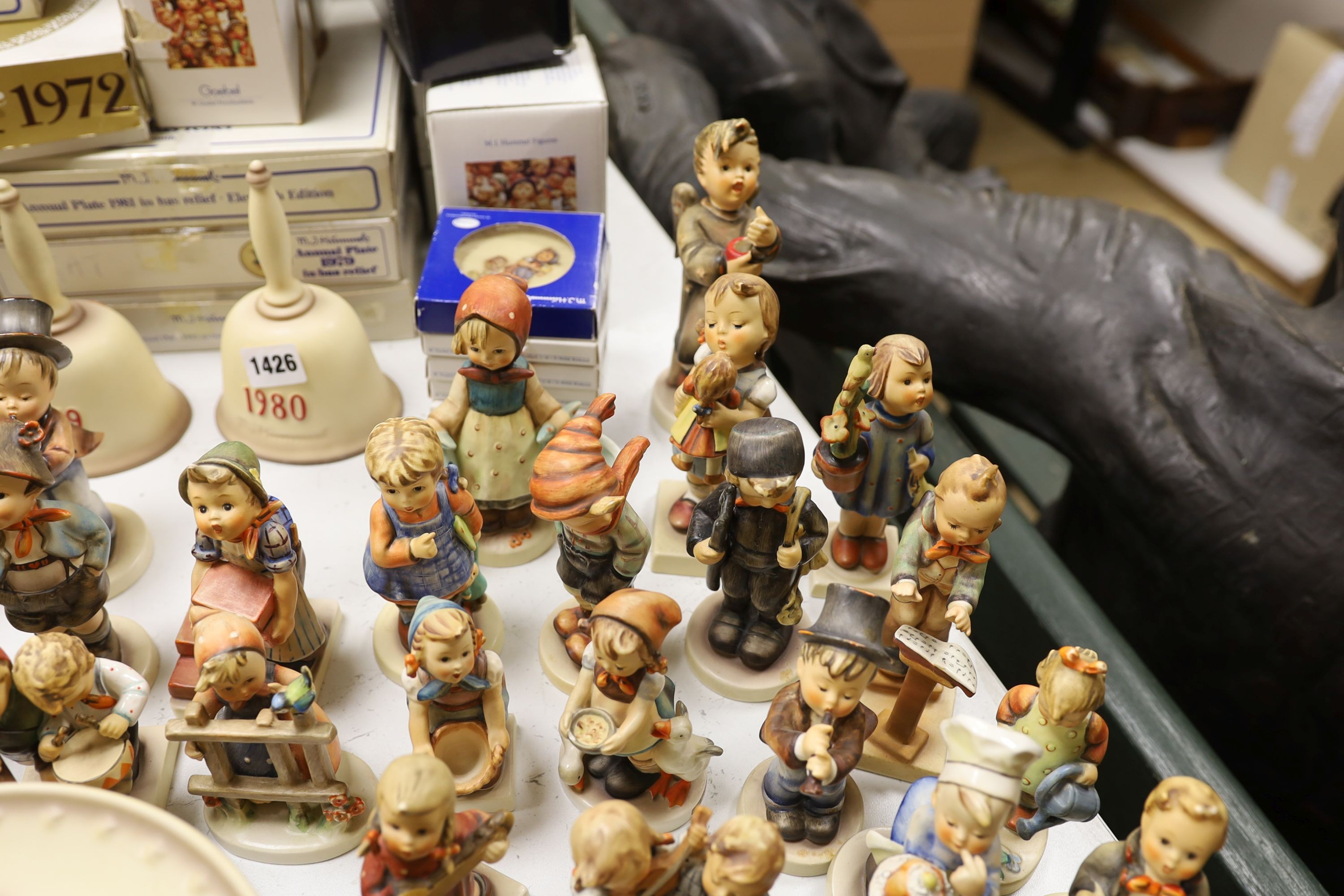 A large collection of Hummel pottery figures, approximately 70 including skier and two similar plaques, some with boxes.